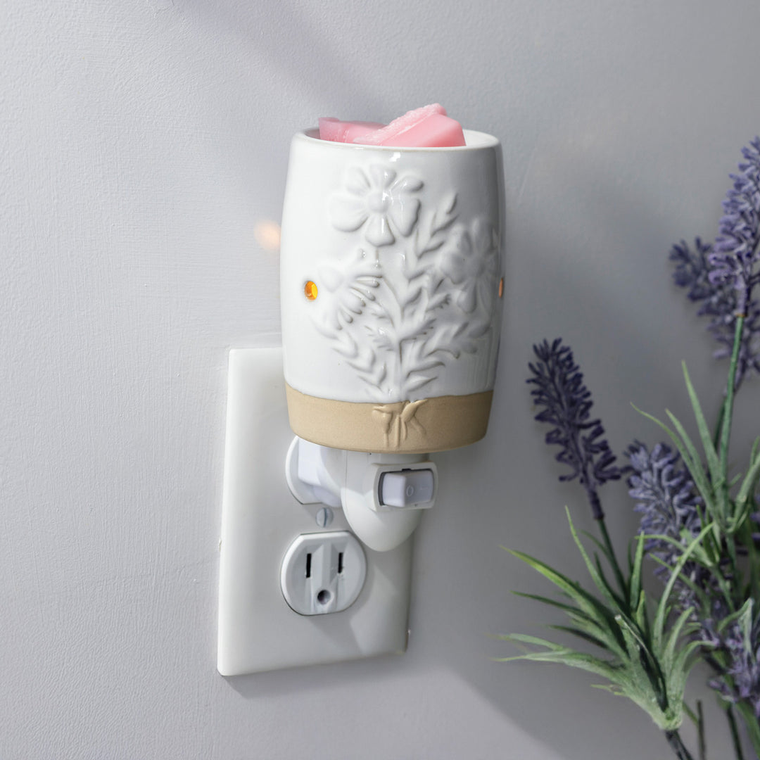 White Garden Blooms floral pluggable fragrance warmer styled in a neutral room with lavender