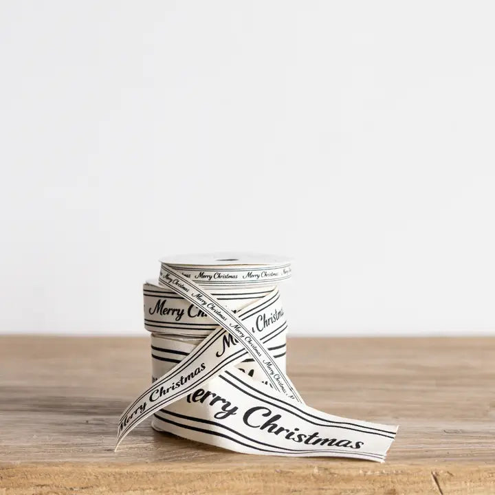 Cream Merry Christmas script ribbon wrapped around stacked spools showing different ribbon widths.