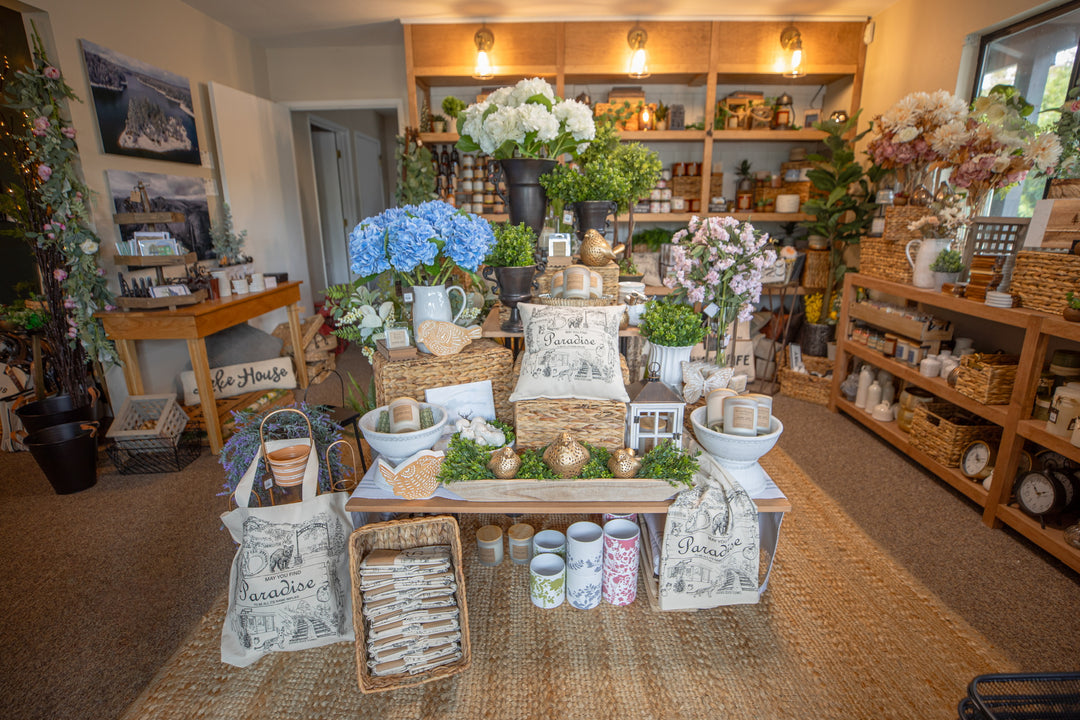 Store interior with floral arrangements, decorative items, and shelves.