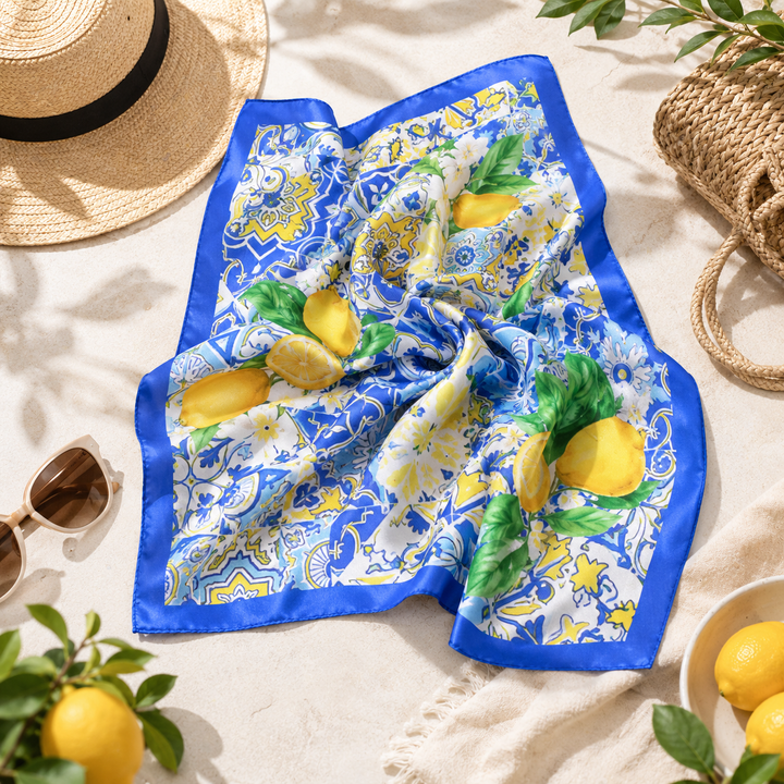 Decorative scarf with lemon and butterfly pattern on a sandy background