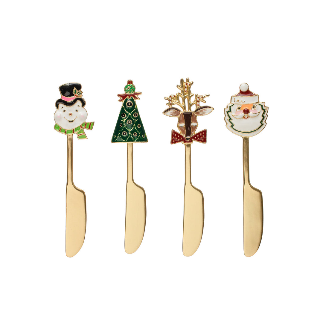 Four gold-handled knives with Christmas-themed heads on a white background