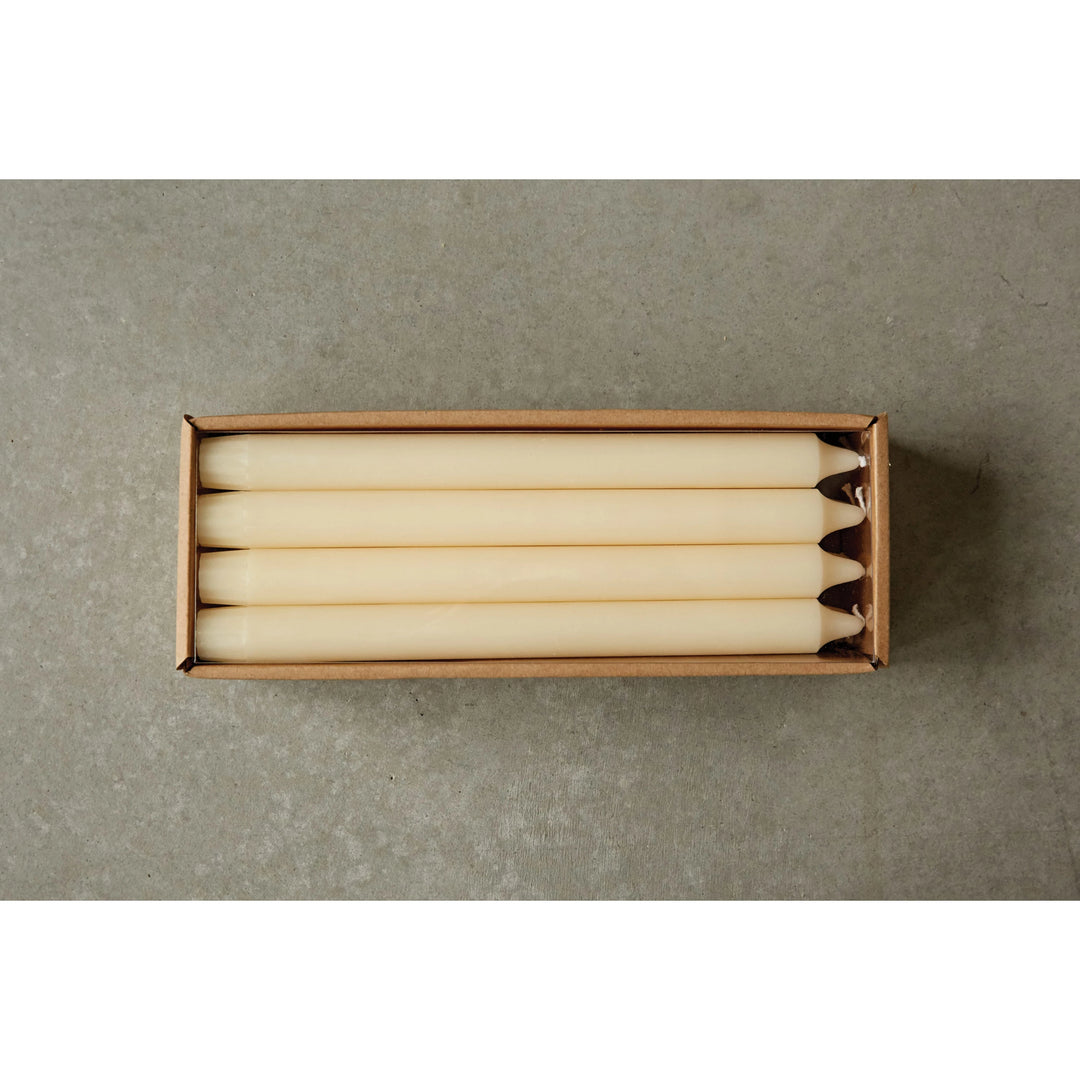 Box of white candles on a gray background