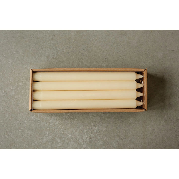 Box of white candles on a gray background