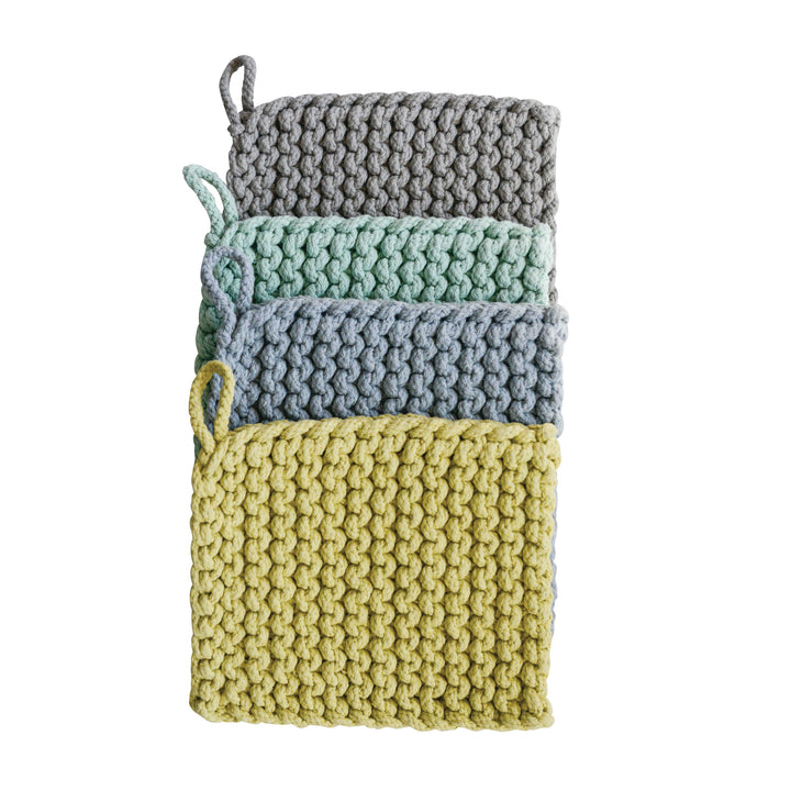 Set of four crocheted pot holders in gray, green, blue, and yellow on a white background