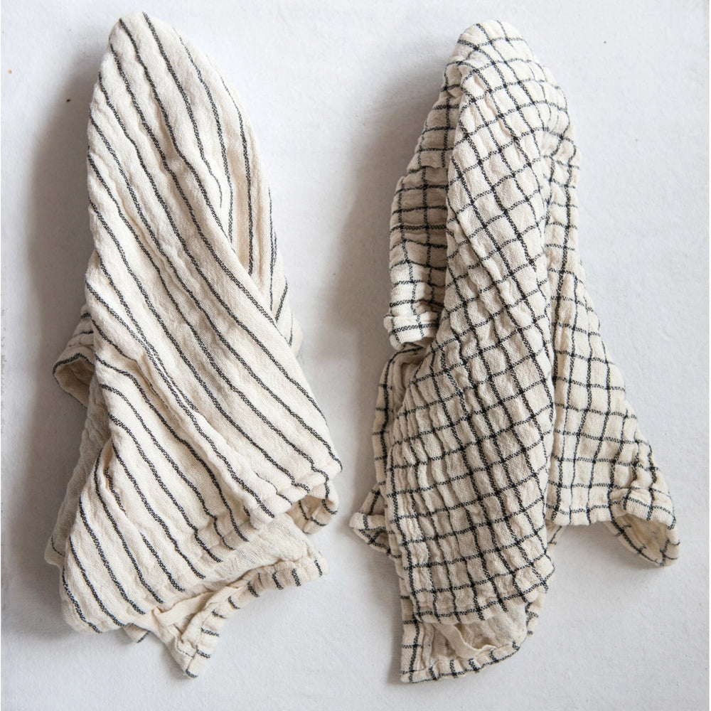 Two fabric items, one striped and one checkered, on a white background