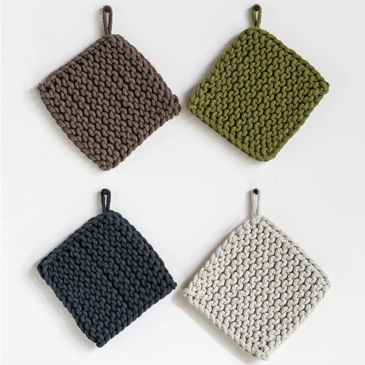 A set of four crocheted pot holders in different colors: brown, green, blue, and beige.