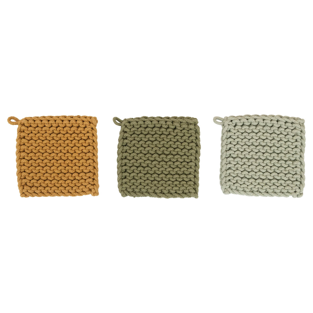 Three knitted pot holders in mustard, green, and beige on a white background