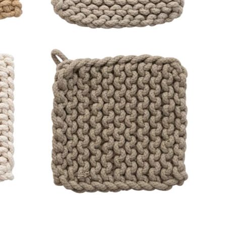 A set of four crocheted pot holders in different colors: brown, green, blue, and beige.