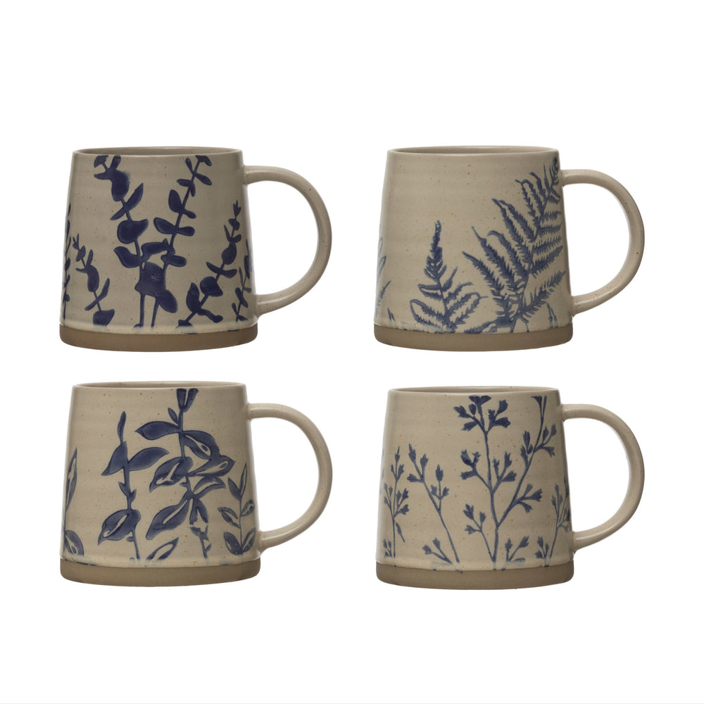 Four ceramic mugs with blue botanical patterns on a beige background