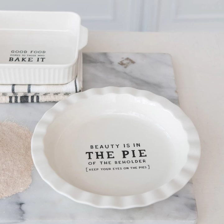 Pie dish with humorous quote on a marble surface