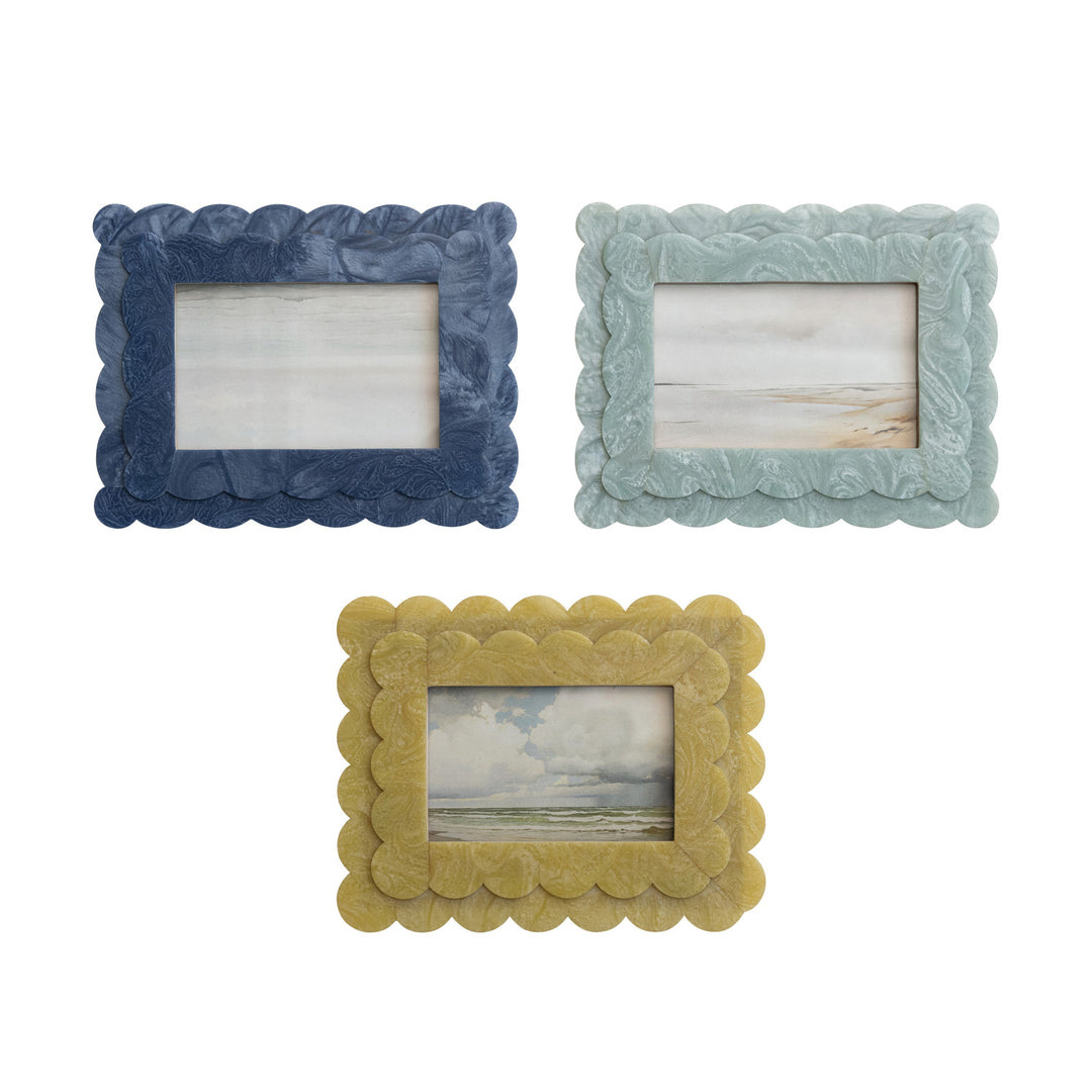 Three decorative picture frames in blue, green, and yellow on a white background