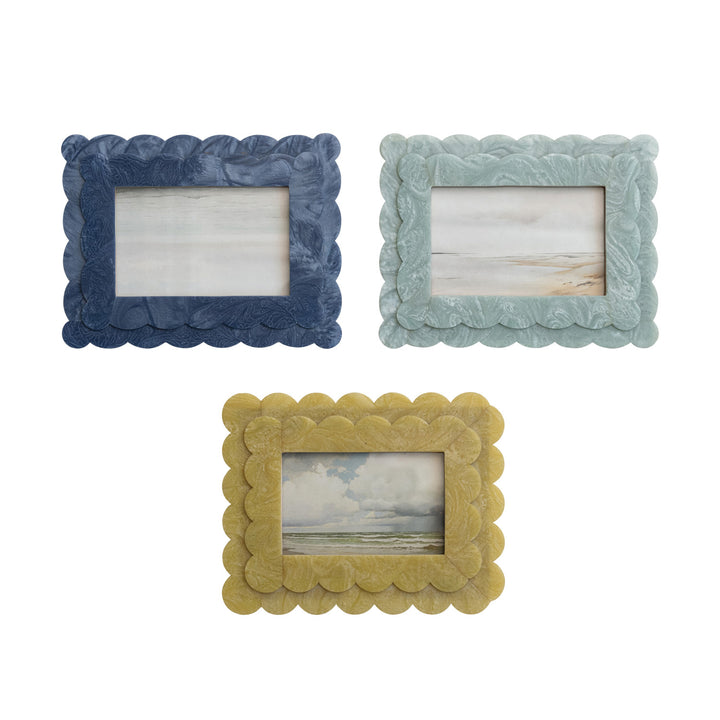Three decorative picture frames in blue, green, and yellow on a white background