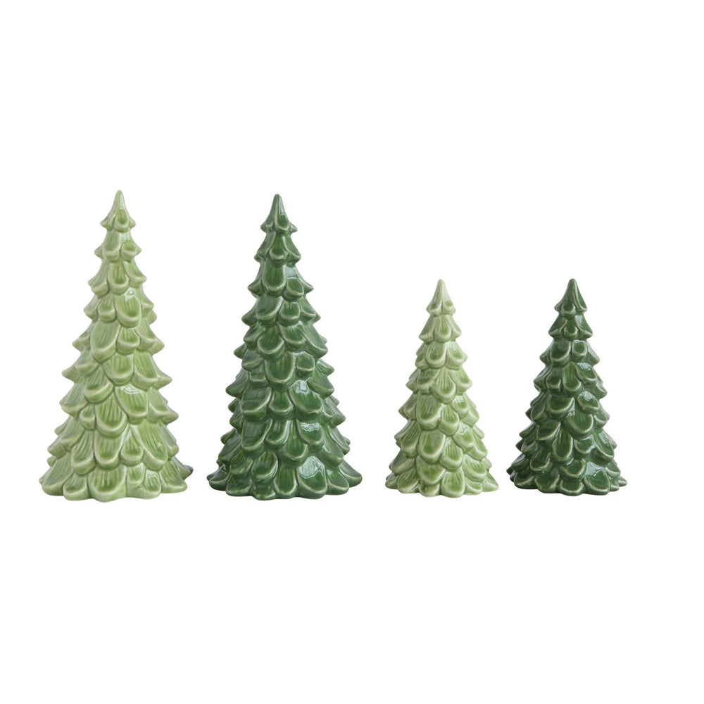 Four small pine tree figurines in various shades of green, arranged in ascending order of height against a plain white background.