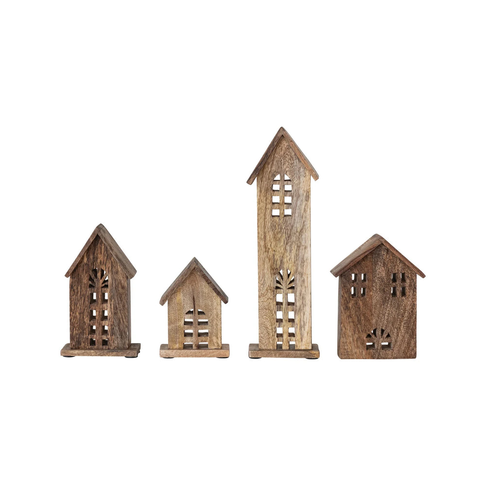 Set of four wooden house-shaped candle holders on a white background