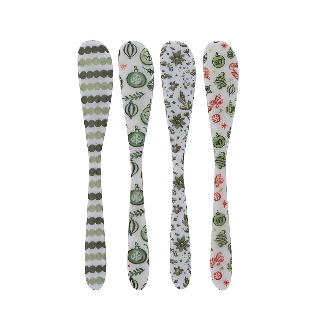 Four decorative spoons with patterned handles on a white background