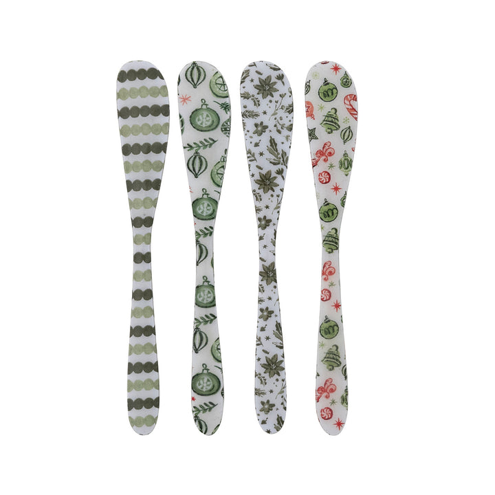 Four decorative spoons with patterned handles on a white background