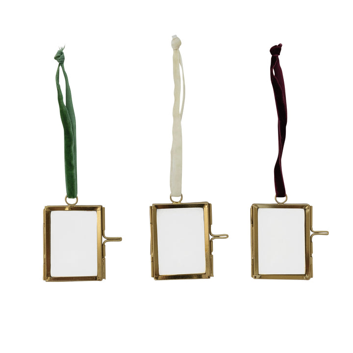 Three gold rectangular photo frames with ribbons on a white background