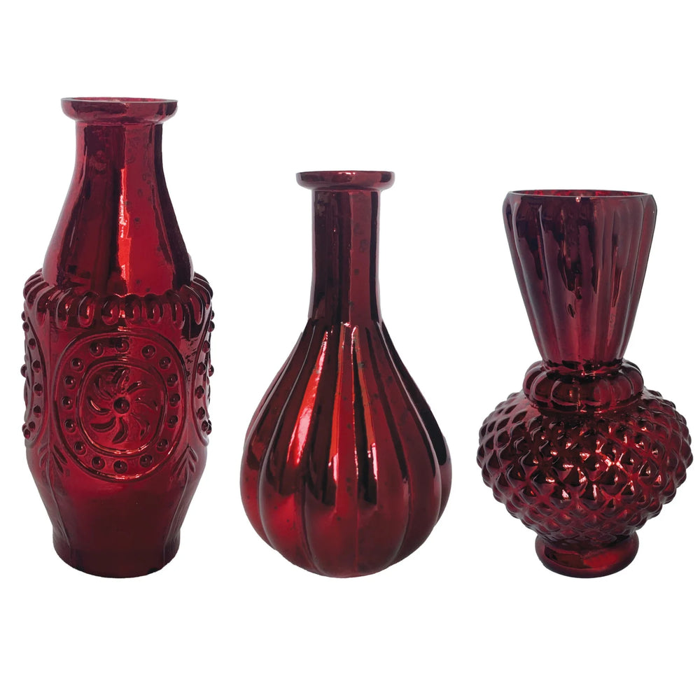 Three red glass vases with textured surfaces on a white background
